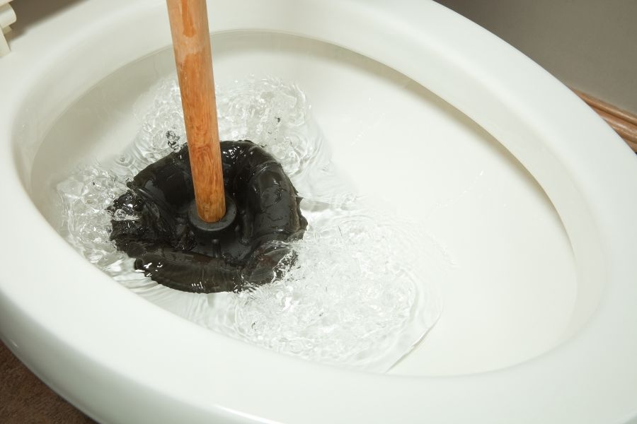 toilet water rises then slowly drains